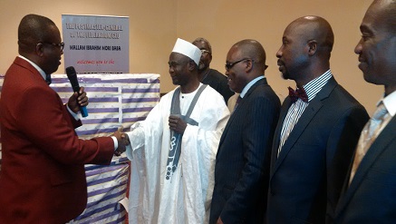 (L-r) Dr. Michael Umo, GM Bulk Post Venture presenting the Ventures' gift to Mallam Mori-Baba, out-going PMG of NIPOST while other guests watch at an event held at Sherston Hotels, Ikeja on Monday.