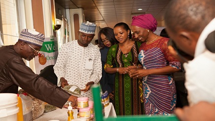 Mrs Dolapo Osinbajo, wife of the Vice President, Federal Republic of Nigeria and Mrs Mobola Sagoe, CEO, Shea Origin being shown the Shea process at the Shea Conference 2015 at Nicon Luxury Hotel, Abuja.